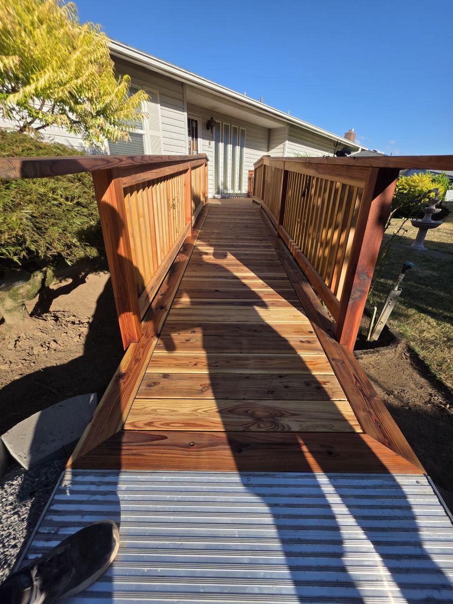 Long cedar walkway ramp with handrails leading to a home entry in Columbia County Oregon