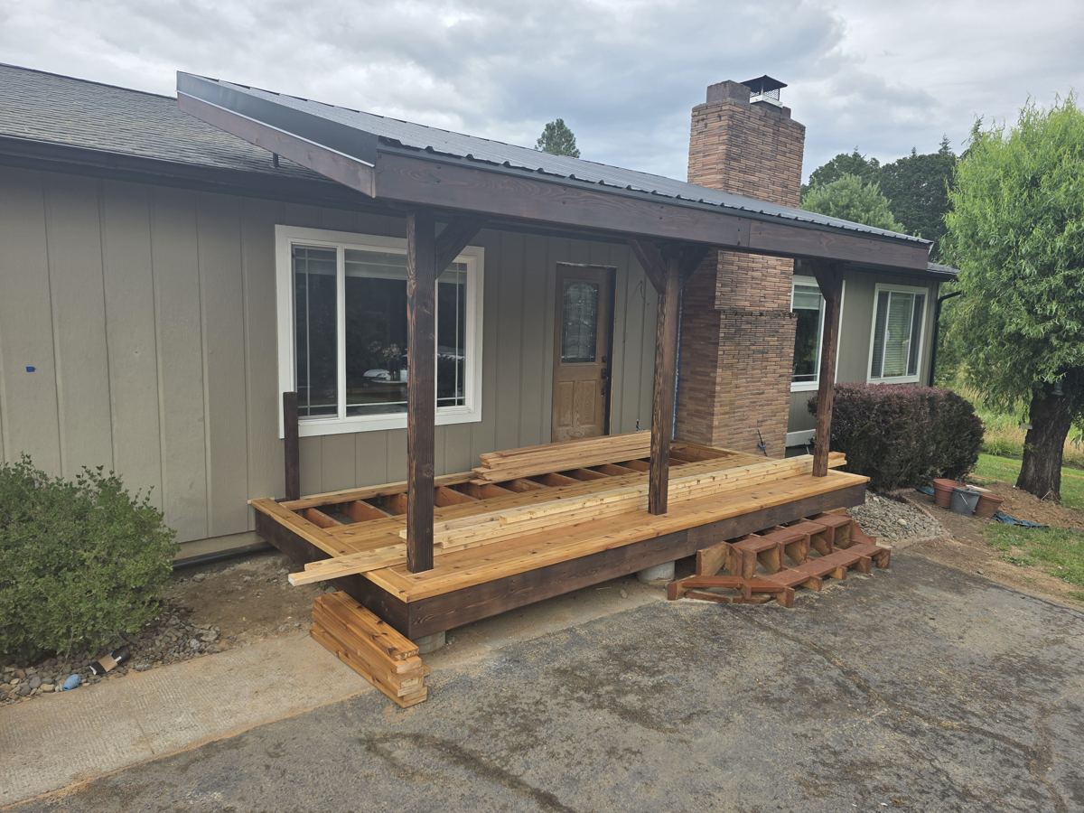 Covered deck framing in progress with posts and joists in Columbia County Oregon