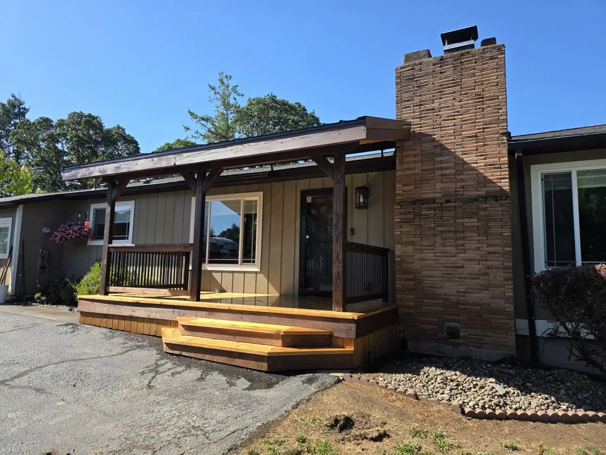 Finished covered front porch with timber posts and cedar steps on a Columbia County Oregon home