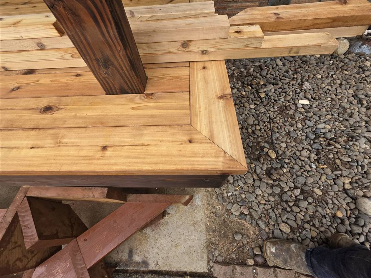 Covered deck construction with stained posts and metal roof in Oregon