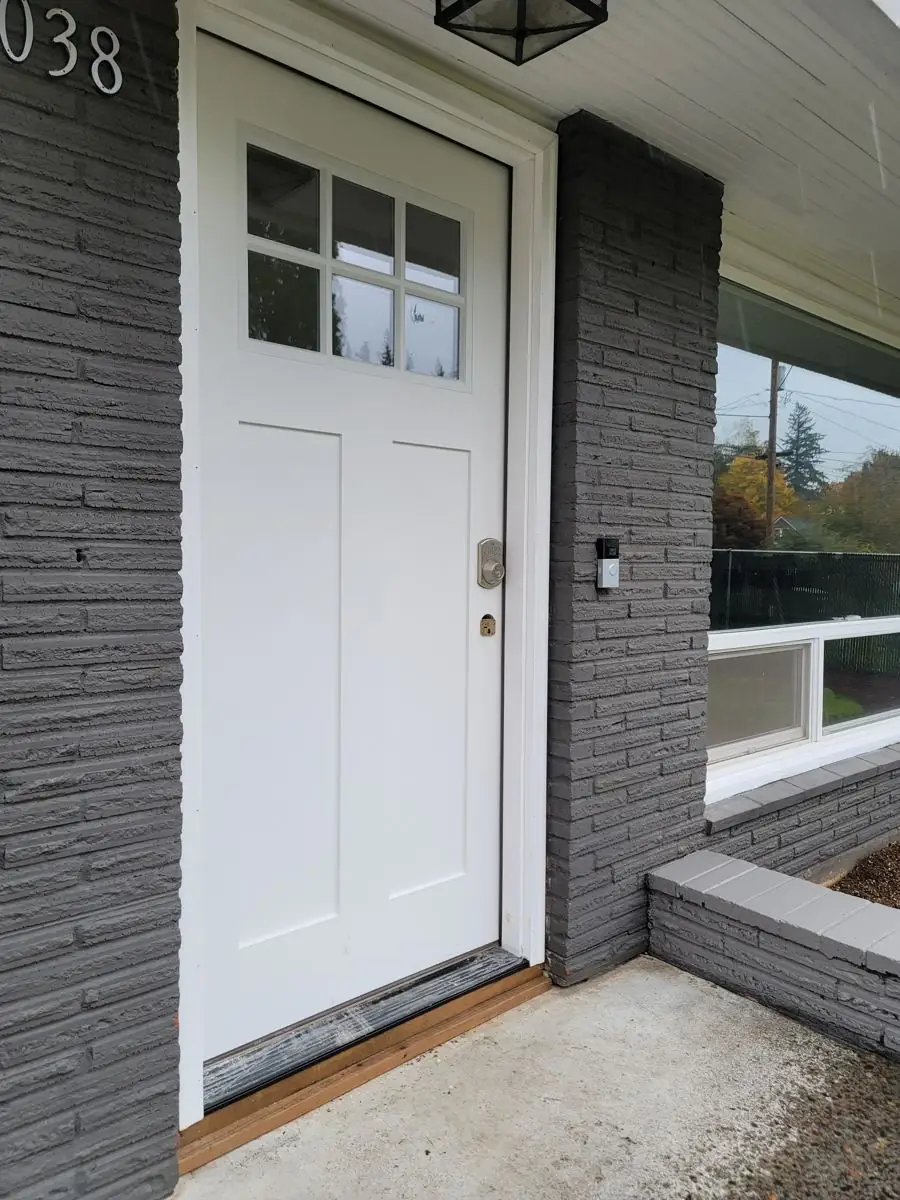 New white craftsman front door with freshly painted brick surround in Columbia County Oregon