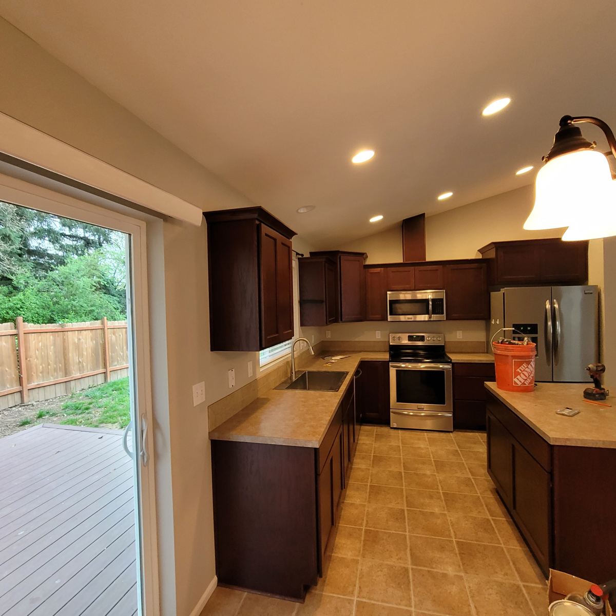 Remodeled kitchen with new cabinets, stainless appliances and tile floor in Columbia County Oregon