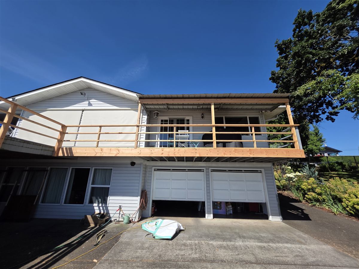 Second-story deck rebuild with new cedar railing on a Columbia County Oregon home